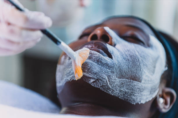 Your beautiful face deserves all the treatment Cropped shot of an attractive young woman getting a facial treatment at a day spa facial chemical peel stock pictures, royalty-free photos & images