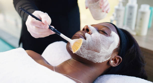 Because a girl's gotta get her facial done Cropped shot of an attractive young woman getting a facial treatment at a day spa facial chemical peel stock pictures, royalty-free photos & images