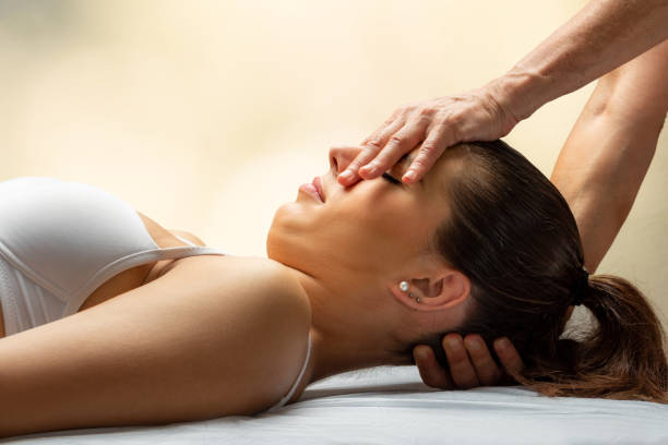 istock Osteopath doing neck and head manipulation on female patient. 1180026134