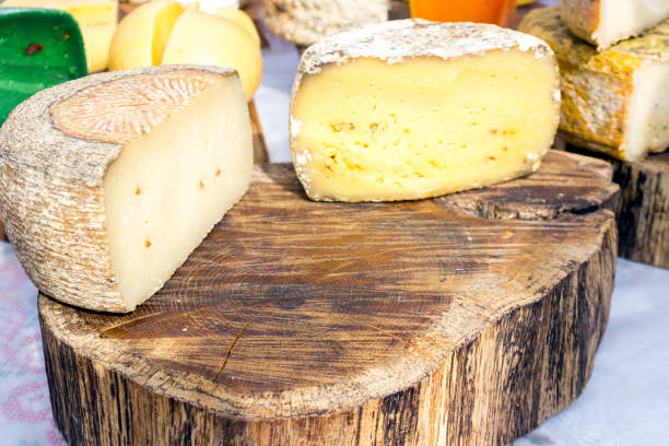 istock Large selection of cheese varieties on a wooden table background. 1180027473