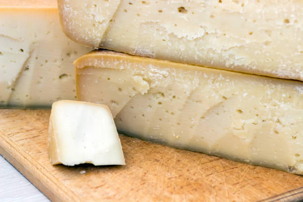 istock hard cheeses sliced on a wooden board on a dark rustic background 1180027766