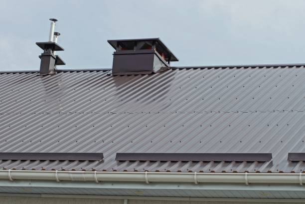 istock many metal chimney pipes on a brown roof 1180028748