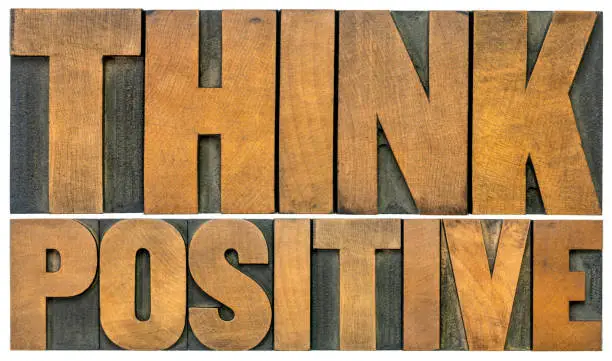 Think positive -isolated  word abstract in vintage letterpress wood type blocks, optimism and mindset concept