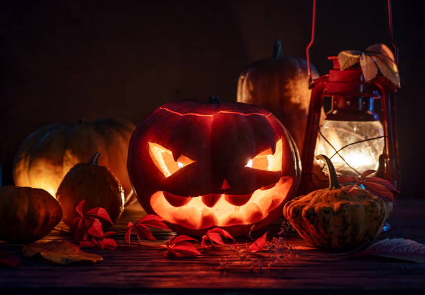 istock Spooky evil scary illuminated halloween pumpkin night horror lantern candle light, happy halloween dark holiday celebration, trick or treat creepy mystery all saints background october eve decoration 1180031262
