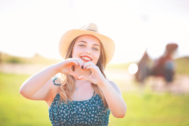 beautiful young woman heart shape with hands