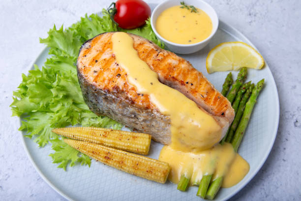 istock Fried salmon with asparagus, mini corn and hollandaise sauce. 1180036965