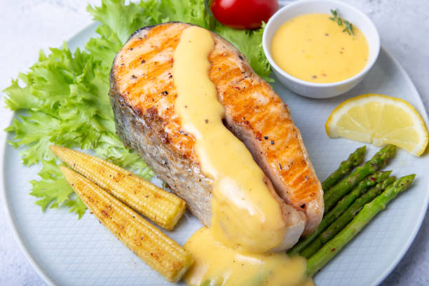 istock Fried salmon with asparagus, mini corn and hollandaise sauce. 1180036989