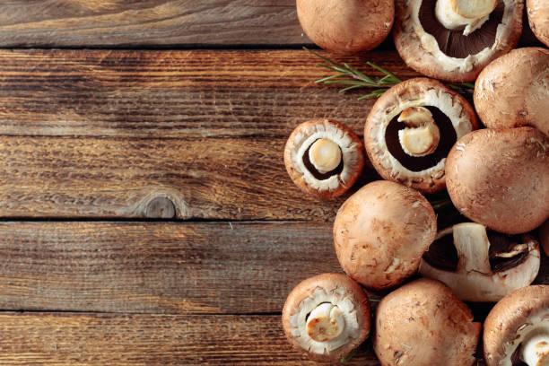 istock Fresh brown mushrooms mushroom on an old wooden table. 1180038566