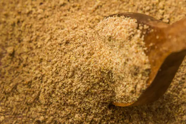 Ground, crushed, milled flaxseed, linseed in wooden spoon