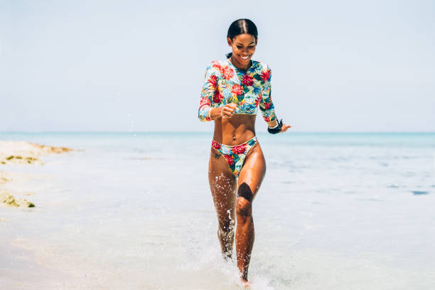 istock Young Black woman at tropical beach 1180040806