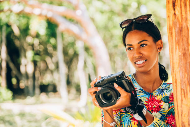 istock Young Black woman with retro digital camera 1180040856