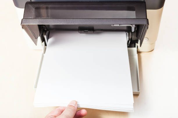putting of white paper sheets in printer tray