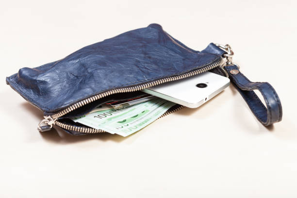 istock handbag with phone, cards and euro notes on table 1180045498