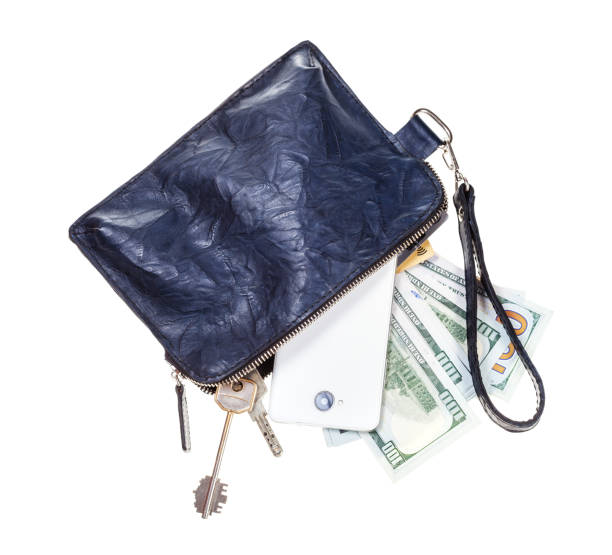 istock purse with phone, keys, cards and dollars isolated 1180046043