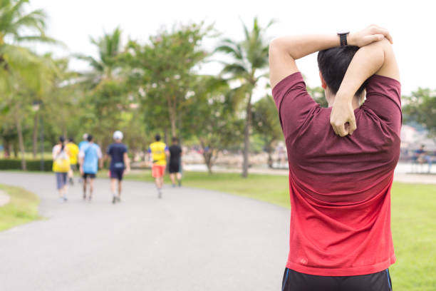 istock Young man stretching his arms before exercising and running. Sport and exercise concept. 1180046338