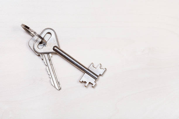 istock door keys on keyring on pale brown table 1180046380