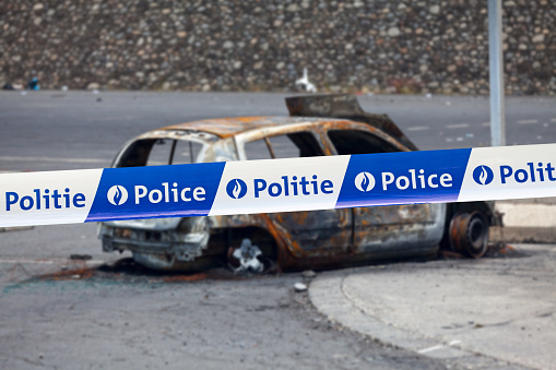 Brussels, Belgium - June 23 2017: Car burnt by a pyromaniac with a police tape with written in it in French \