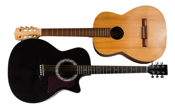 istock Two acoustic guitars, light and black. Isolated on white 1180047940