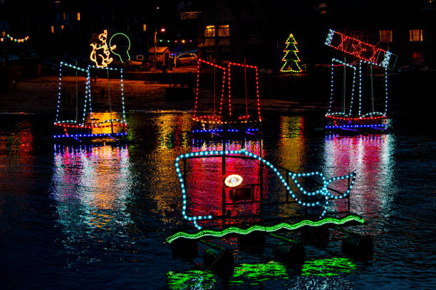 istock Christmas lights in a harbour lit up and floating on the water 1180053615