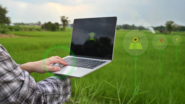 istock Agriculture technology attractive farmer navigating farmland with laptop computer  innovations for increasing productivity in agriculture. 1180053759