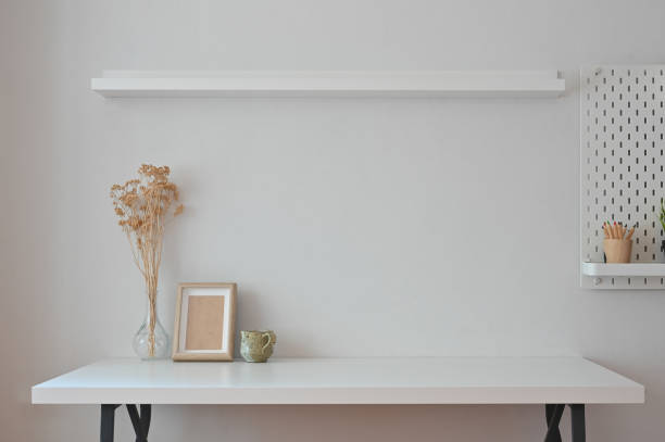 istock Workspace photo frame, coffee, dry flower with shelves and peg board. 1180053885