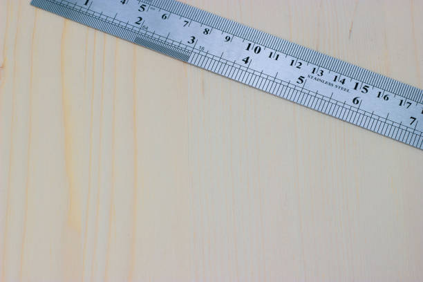 istock metal carpentry ruler on a light wooden background 1180054082