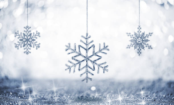 istock Hanging Snowflakes against Glittering Defocused Background 1180055082