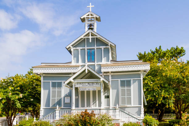 istock Unique White Church With Wooden Doors And Cross At Highest Point 1180055691