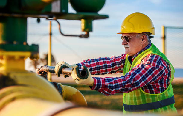 istock Worker checking valves on the fuel supply systems. Concept of industry 1180055747
