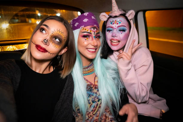 Night out with the girls Girls riding in a taxi to the Halloween party and taking selfies. selfie girl stock pictures, royalty-free photos & images