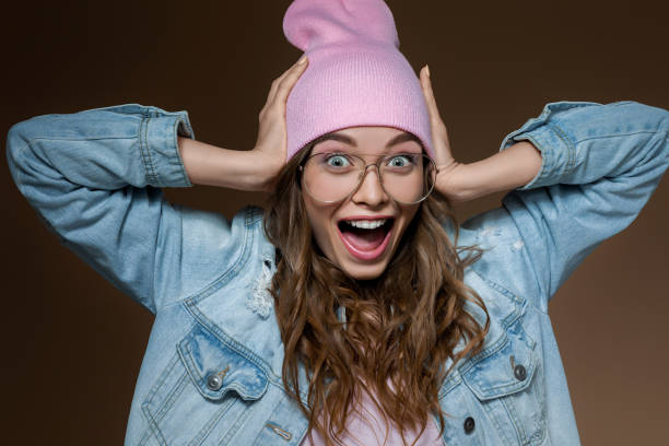 istock surprised beautiful woman in jeans jacket 1180056752