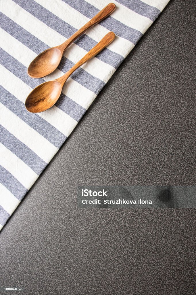 Nature concept. Wooden spoon and kitchen towel. Spoon, kitchen towel. Copy space. Place for your design. Nature concept. Wooden spoon and kitchen towel. Spoon, kitchen towel. Copy space. Place for your design. Grey background. Above Stock Photo
