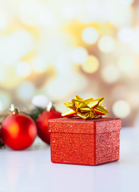 istock Christmas or new year decorations, red gift box and balls with  bokeh lights 1180060778