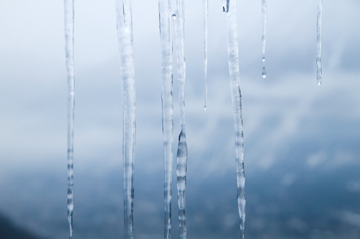 Detail of icicle formation in a window, abstract wintry nature background