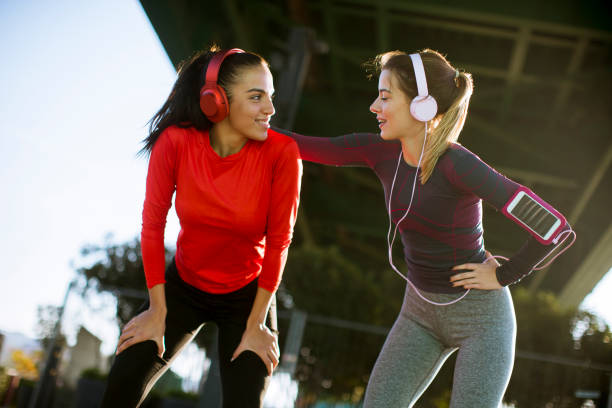 istock Two young women doing gymnastic exercises outdoor 1180062268