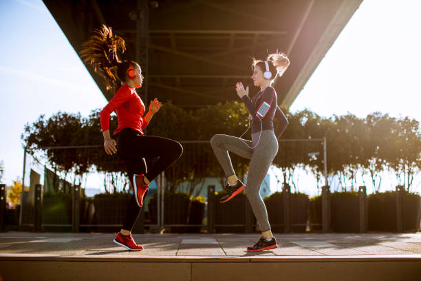 istock Two young women doing gymnastic exercises outdoor 1180062271