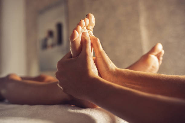 istock Young woman receiving foot massage 1180062454