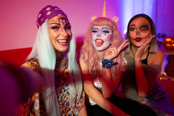 Halloween girls Girls taking selfies at Halloween party. carnival costume stock pictures, royalty-free photos & images