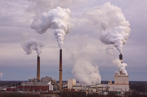 Wide angle shot of a coal burning power plant and the air pollution.