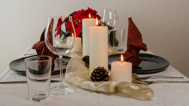 istock Christmas table setting for two, with four candels, blue plates and a red table napkin. 1180063750