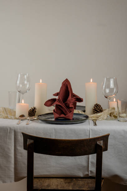 istock Christmas minimal table setting for two, with four candels, blue plates and a red table napkin 1180063832