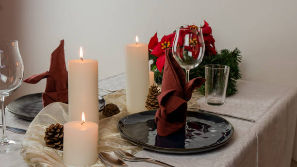 istock Christmas table setting for two, with four candels, blue plates and a red table napkin. 1180063842