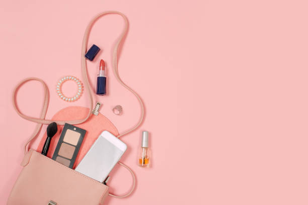 istock Top view of Women bag and lady stuff with copyspace on pink background 1180064310