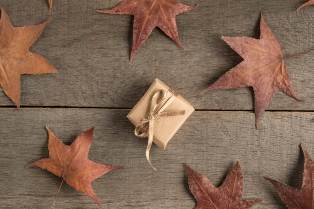 istock gift box on a wooden table decorated with dried autumn leaves 1180065938