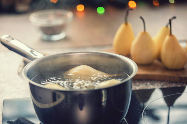 istock Preparing poached pears glazed with dark chocolate for the holidays 1180068580