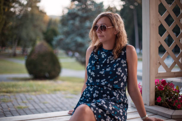 istock Woman in a park 1180069630