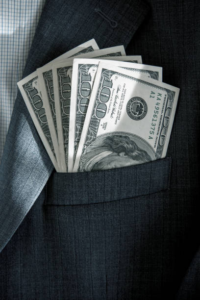 istock Abstract image with dollars in the pocket of jacket (corruption, lobbying, bribery - concept). 1180069669