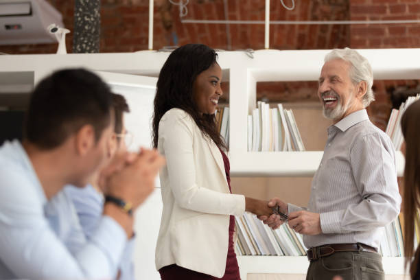 istock Smiling multiracial businesspeople handshake greeting at meeting 1180069918