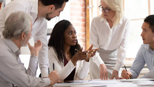 istock Multiracial colleagues brainstorming discussing ideas at meeting 1180069954