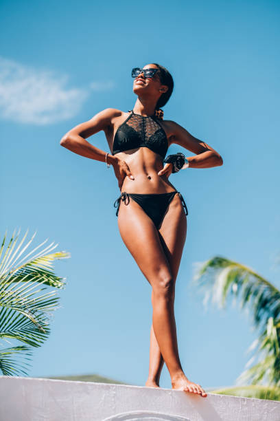 Young Black woman at resort pool
